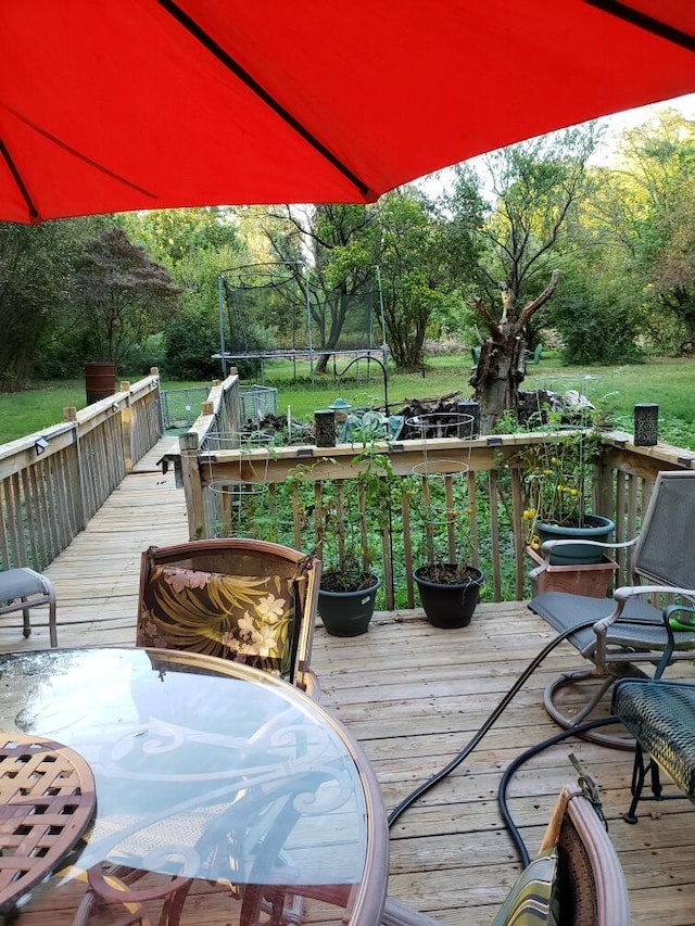 wooden deck with a trampoline