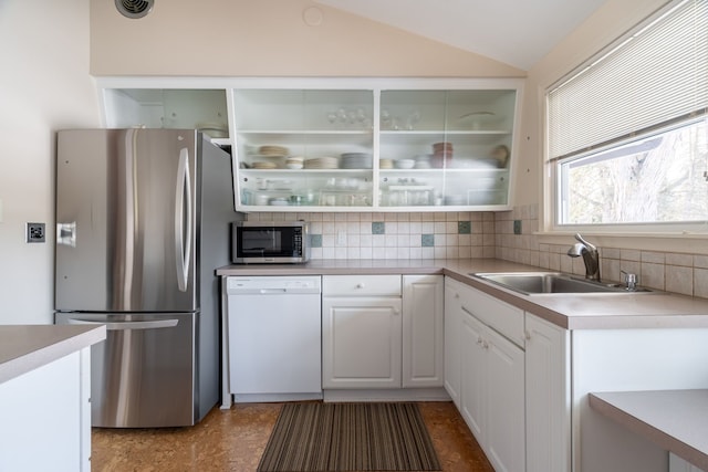 kitchen with a sink, white cabinetry, light countertops, appliances with stainless steel finishes, and tasteful backsplash