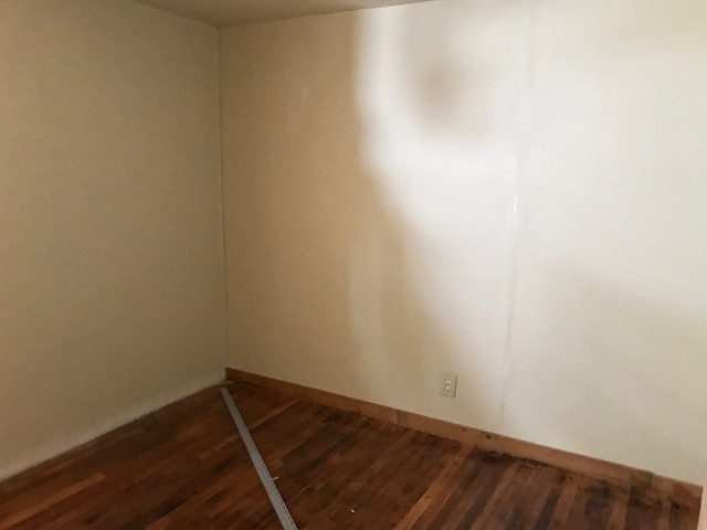 empty room featuring dark wood-type flooring