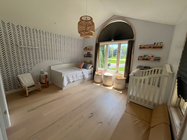 bedroom featuring lofted ceiling and light hardwood / wood-style flooring