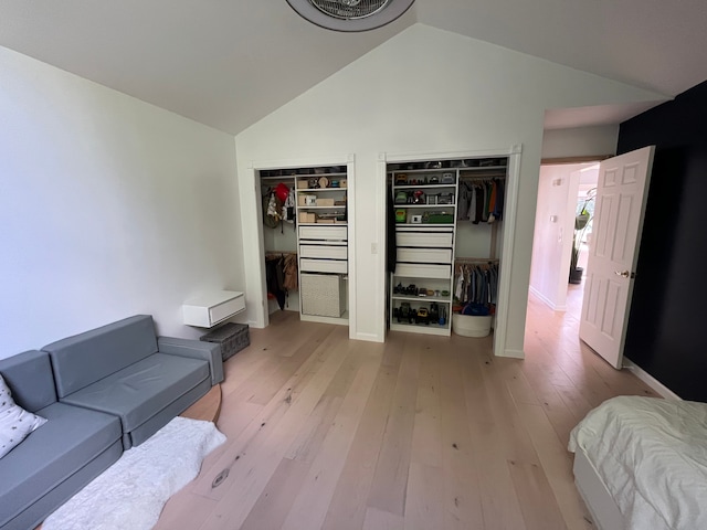 living room featuring vaulted ceiling and light hardwood / wood-style floors