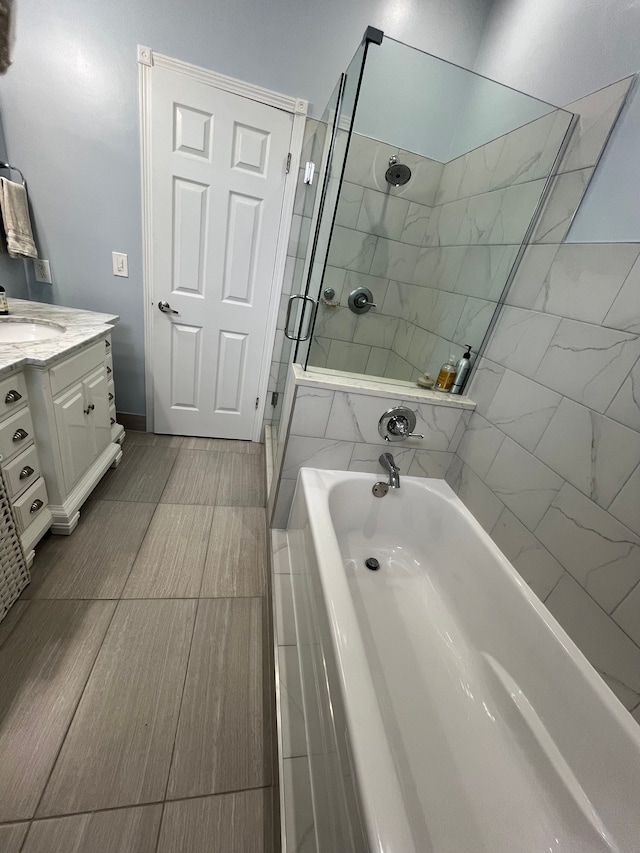 bathroom with vanity and separate shower and tub