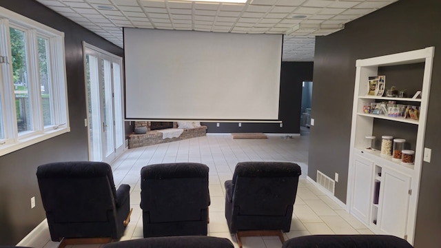 cinema room with built in shelves and a paneled ceiling