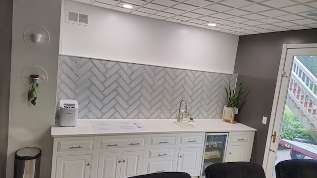 laundry room featuring wine cooler and wet bar