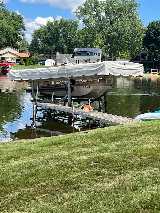 dock area featuring a water view and a yard