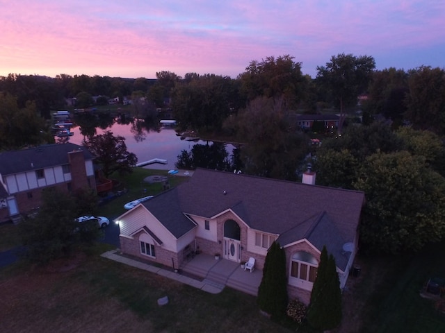 aerial view at dusk with a water view