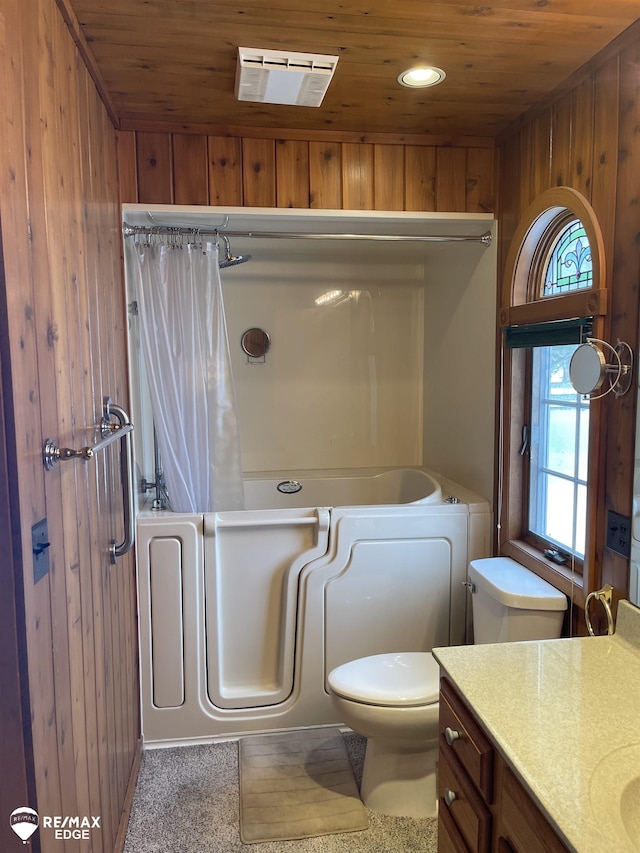 bathroom featuring toilet, wooden ceiling, vanity, wooden walls, and a tub