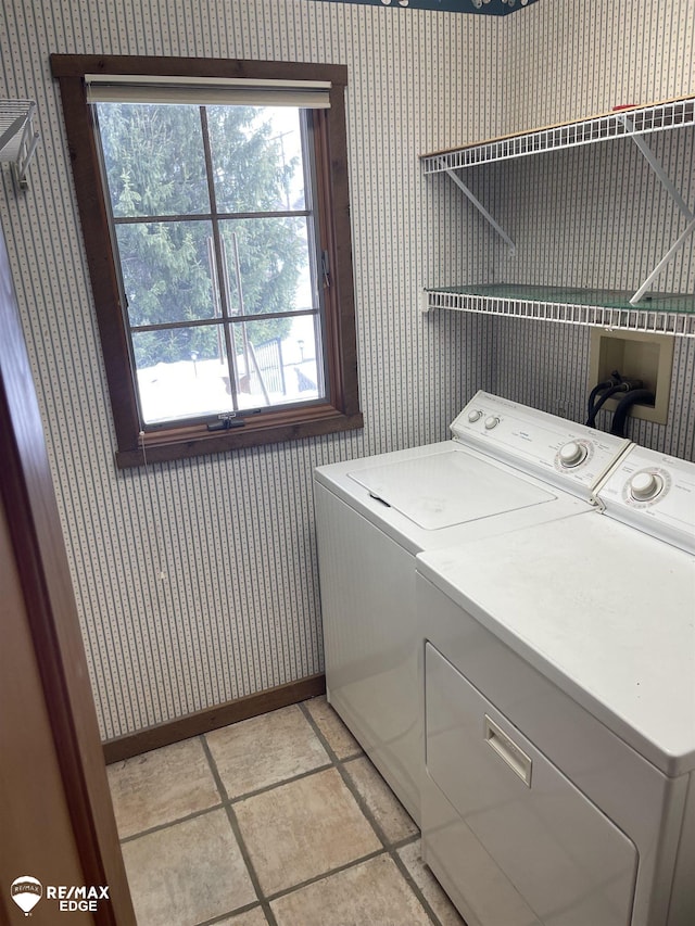 clothes washing area with light tile patterned floors and independent washer and dryer