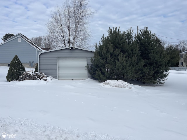 exterior space featuring a garage and an outdoor structure