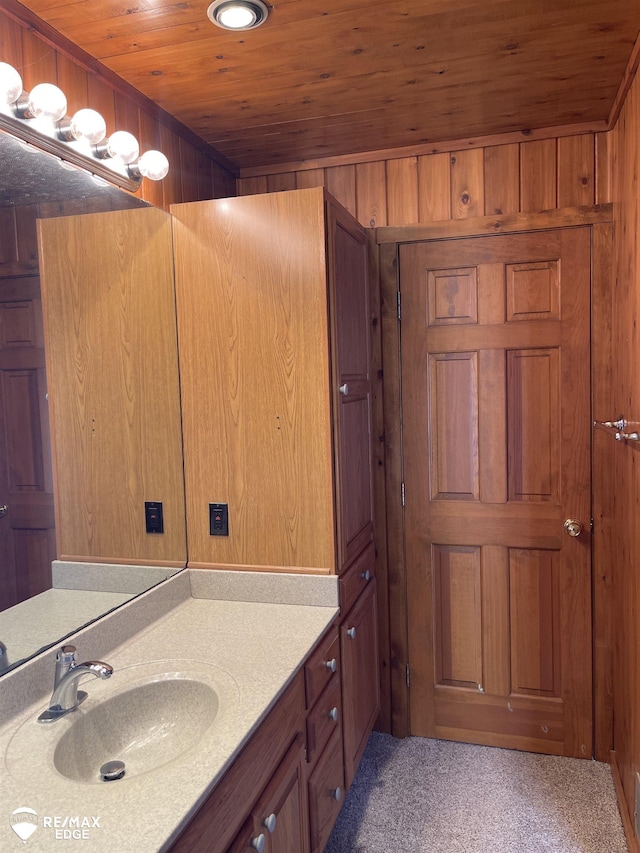 bathroom with vanity, wooden walls, and wooden ceiling