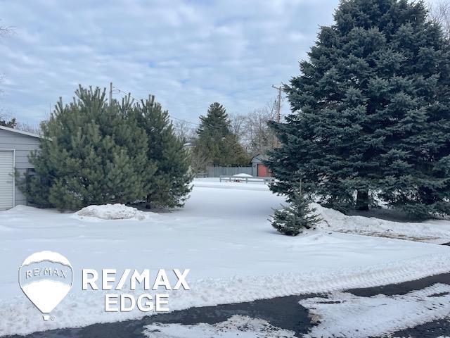 view of yard layered in snow