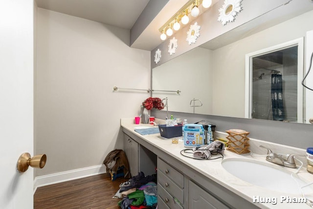 bathroom with hardwood / wood-style flooring and vanity