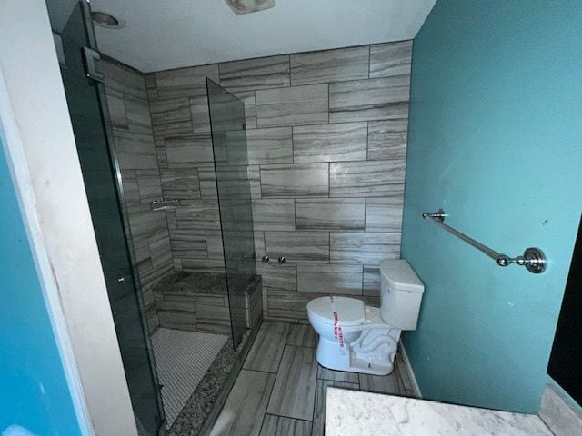 full bath with a stall shower and toilet