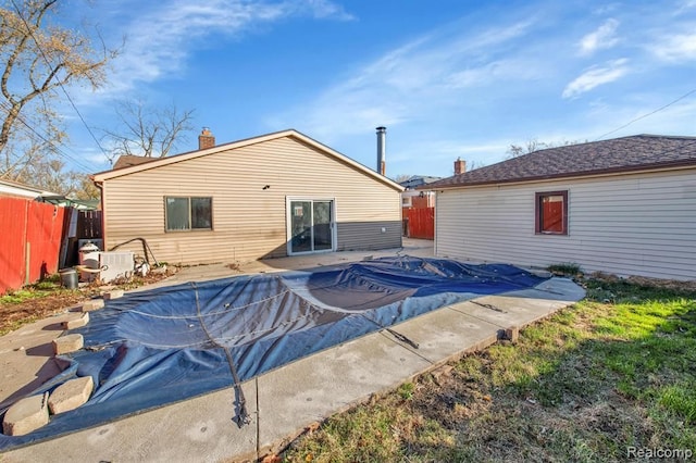 back of house featuring a covered pool