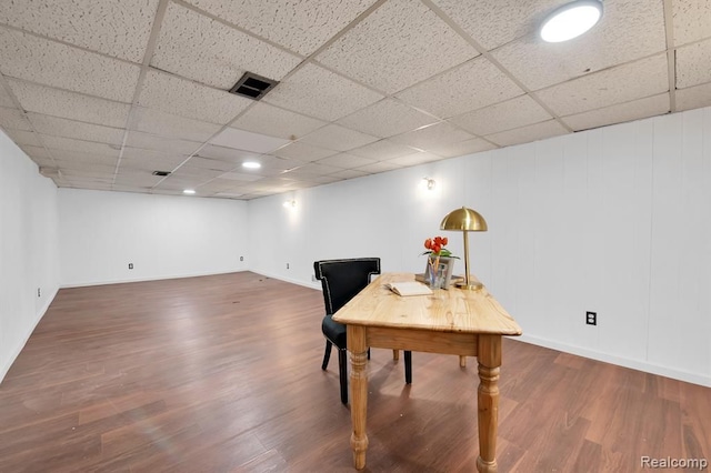 office with a paneled ceiling and dark hardwood / wood-style floors