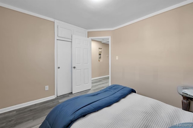 bedroom with hardwood / wood-style flooring and a closet