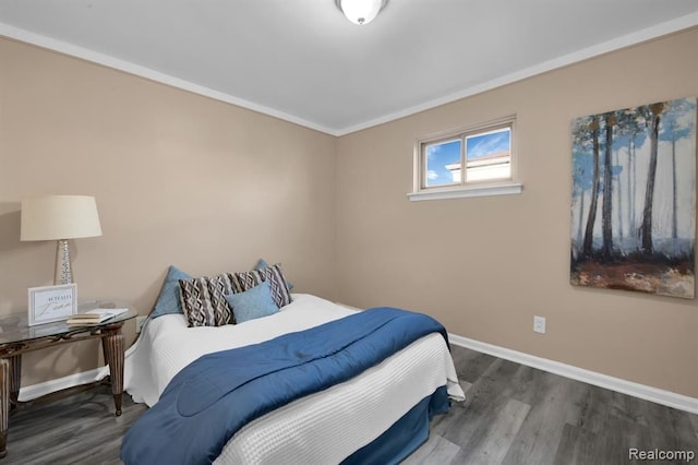 bedroom featuring dark wood-type flooring and ornamental molding