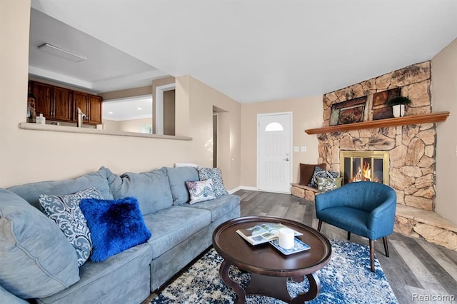 living room featuring a fireplace and hardwood / wood-style floors