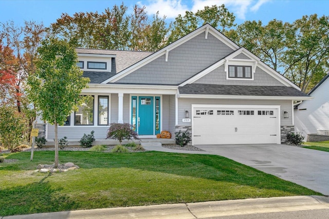 craftsman house with a garage and a front yard