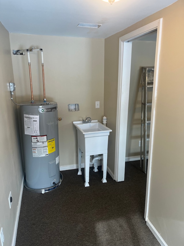 utility room featuring water heater