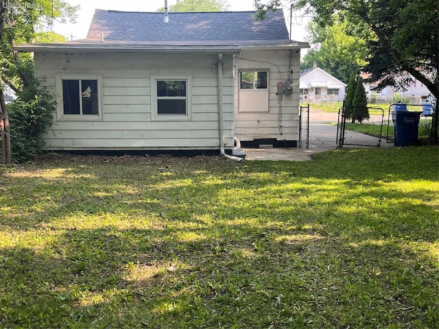 7020 Packard Ave, Warren, MI 48091 - rear view of property featuring a gate and roof with shingles
