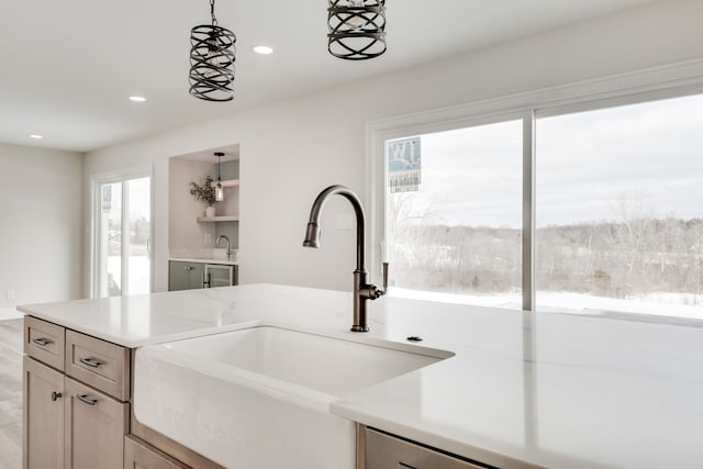 kitchen with decorative light fixtures, light countertops, open shelves, a sink, and recessed lighting