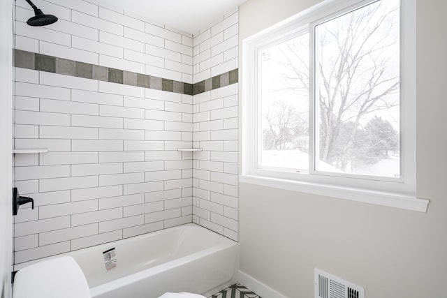 full bath featuring toilet, baseboards, visible vents, and bathing tub / shower combination