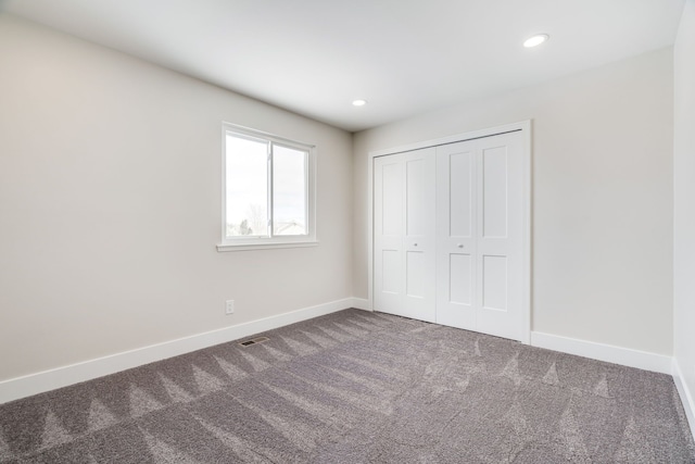 unfurnished bedroom with recessed lighting, carpet flooring, visible vents, and baseboards