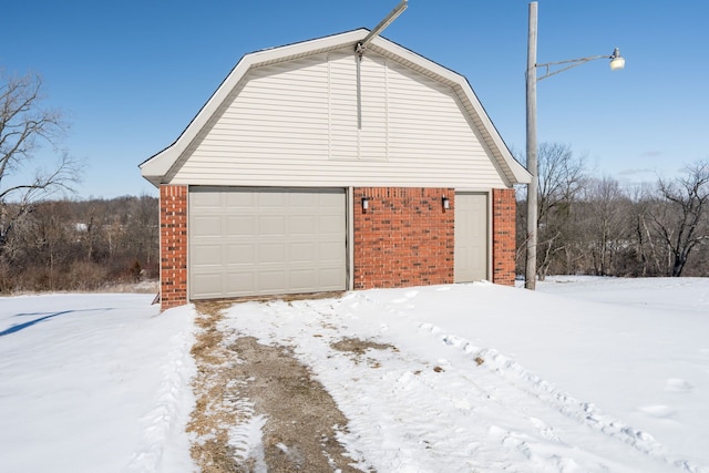 snow covered garage with a garage