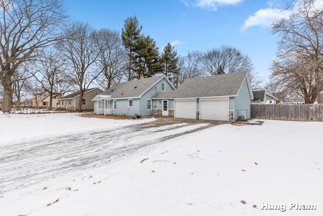 snow covered house with a garage