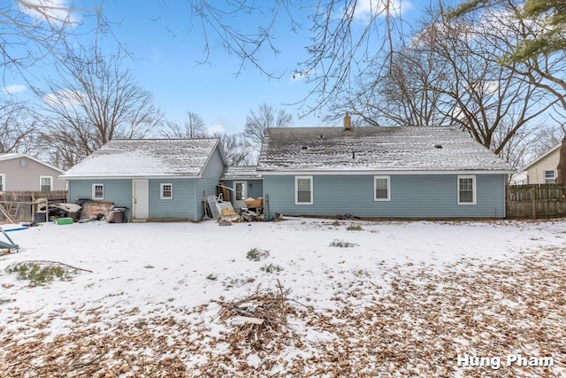 view of snow covered rear of property