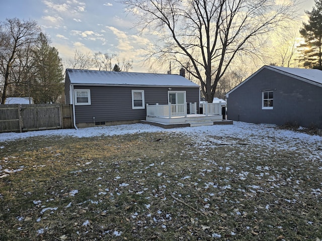 snow covered property with a wooden deck