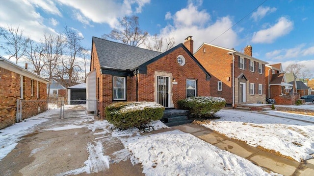 view of front of house with a garage and an outdoor structure