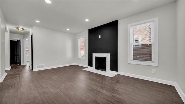 unfurnished living room with dark hardwood / wood-style floors