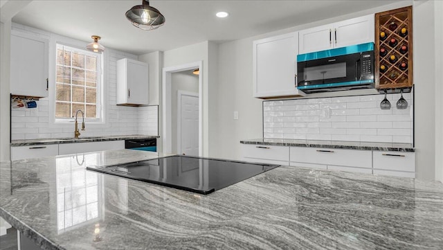 kitchen with sink, decorative backsplash, dark stone counters, and white cabinets