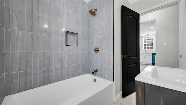 bathroom with vanity, tile patterned floors, and tiled shower / bath