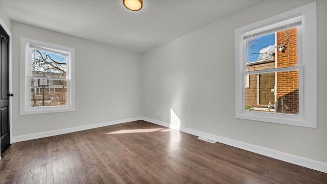 spare room featuring dark hardwood / wood-style floors