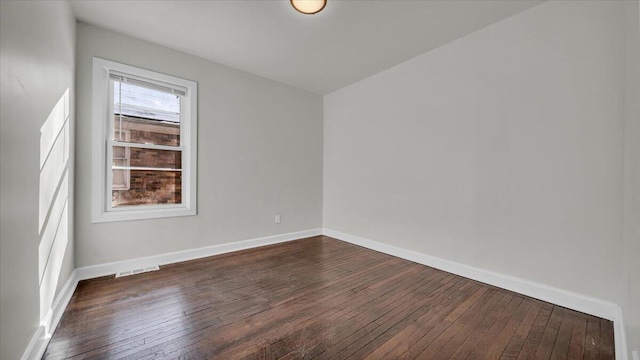 empty room featuring dark wood-type flooring