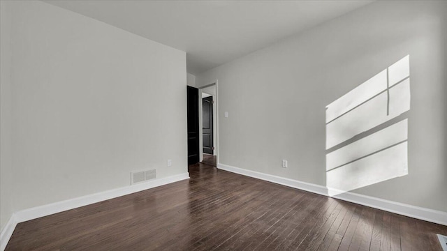 unfurnished room with dark wood-type flooring