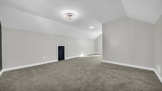 additional living space featuring carpet floors and vaulted ceiling