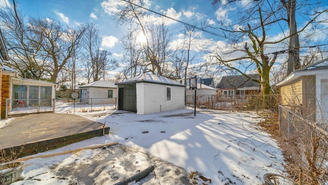 snow covered property featuring an outdoor structure