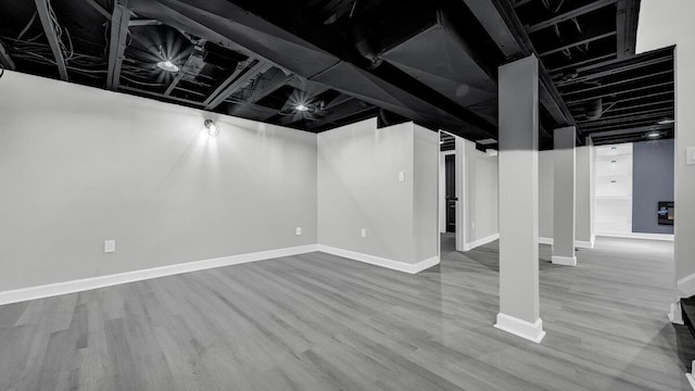 basement featuring hardwood / wood-style floors