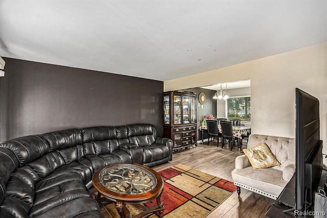 living room featuring an inviting chandelier and wood-type flooring