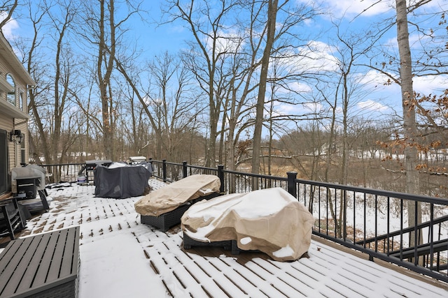 snow covered deck with grilling area