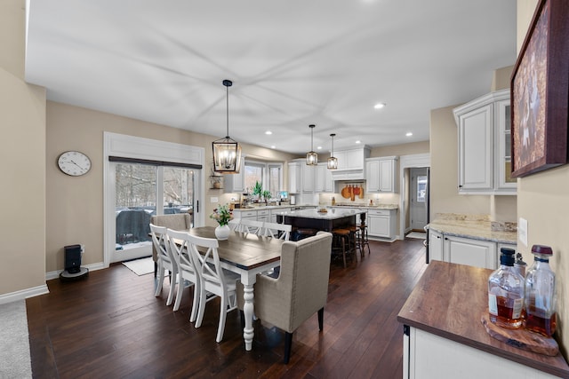 dining room with baseboards, dark wood-type flooring, and recessed lighting