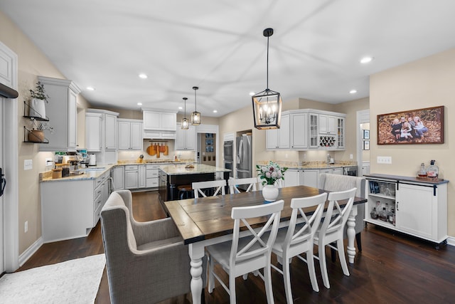 dining area with baseboards, dark wood finished floors, and recessed lighting