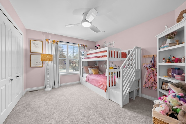 carpeted bedroom with a closet, visible vents, ceiling fan, and baseboards