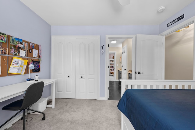 bedroom featuring a closet, light carpet, and baseboards