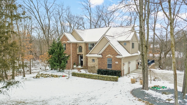 view of front of home featuring a garage and brick siding