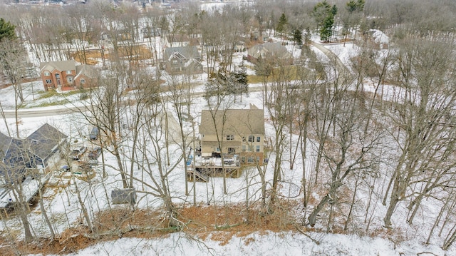 snowy aerial view with a residential view